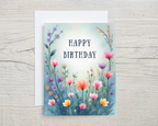 Birthday card with colorful flowers and 'Happy Birthday' text on a wooden surface