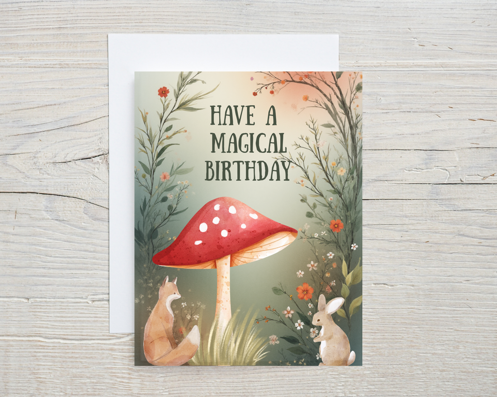 Greeting card with a red mushroom, fox, and rabbit on a wooden surface