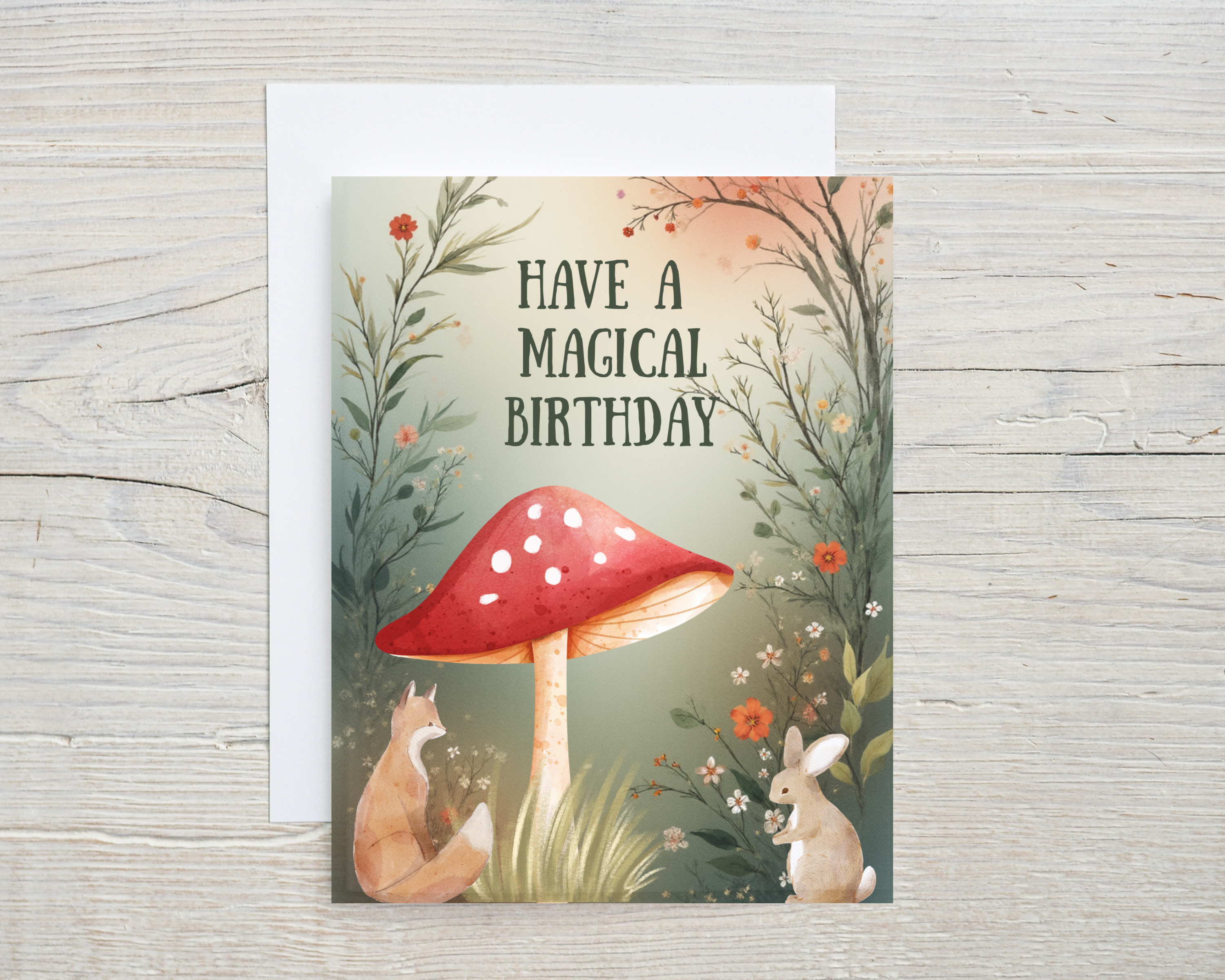 Greeting card with a red mushroom, fox, and rabbit on a wooden surface