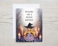Greeting card with a witch design and 'Witching you a Wicked Birthday' text on a wooden surface.
