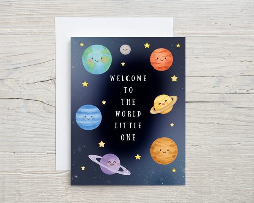 Greeting card with cartoon planets and stars on a wooden surface