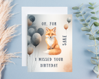 Birthday card with fox and balloons on a blue background with text  "Oh for fox sake I missed your birthday"