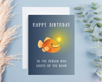 Birthday card with a cute cartoon angler fish on a blue background "Happy birthday to the person who lights up the room" 