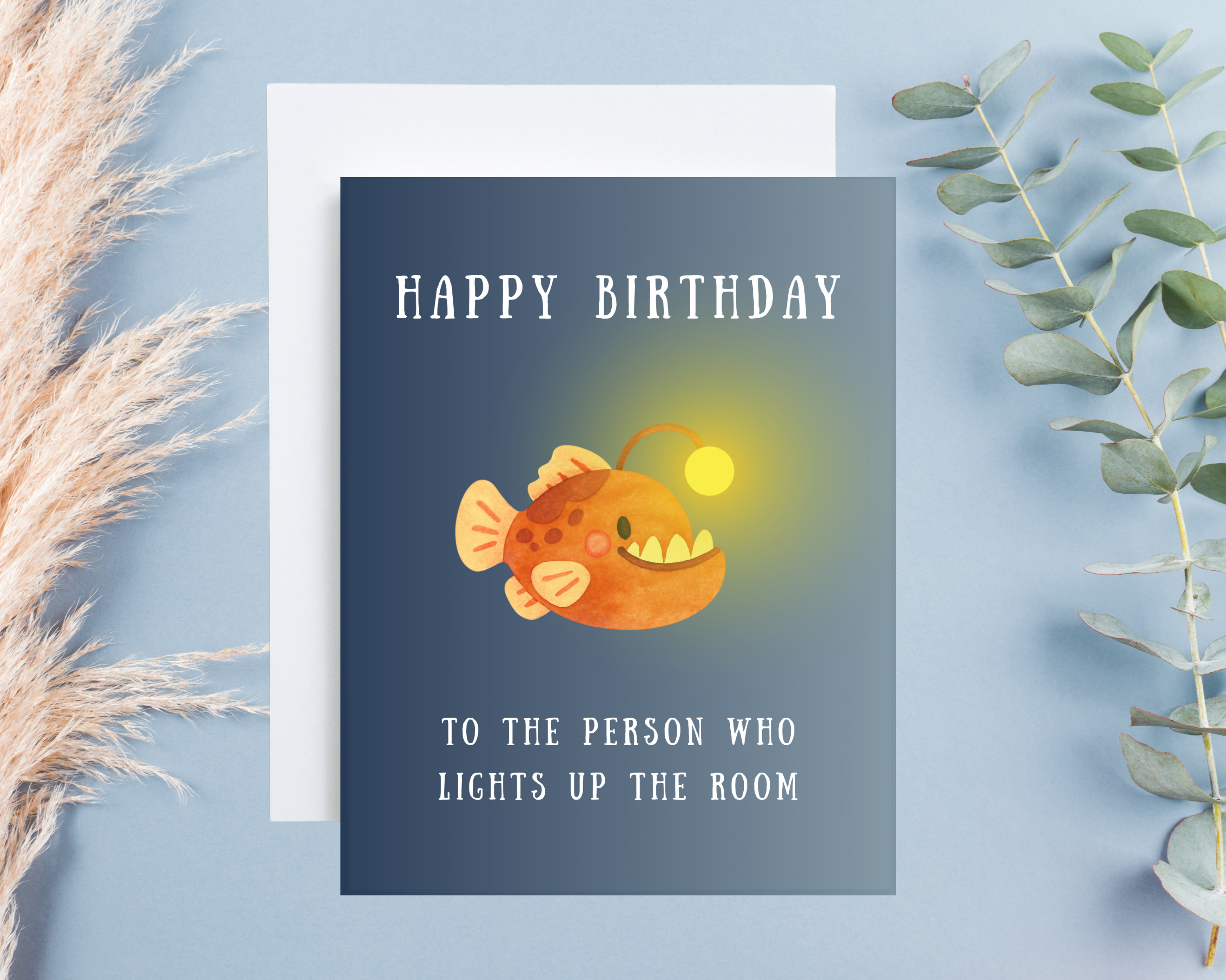 Birthday card with a cute cartoon angler fish on a blue background "Happy birthday to the person who lights up the room" 