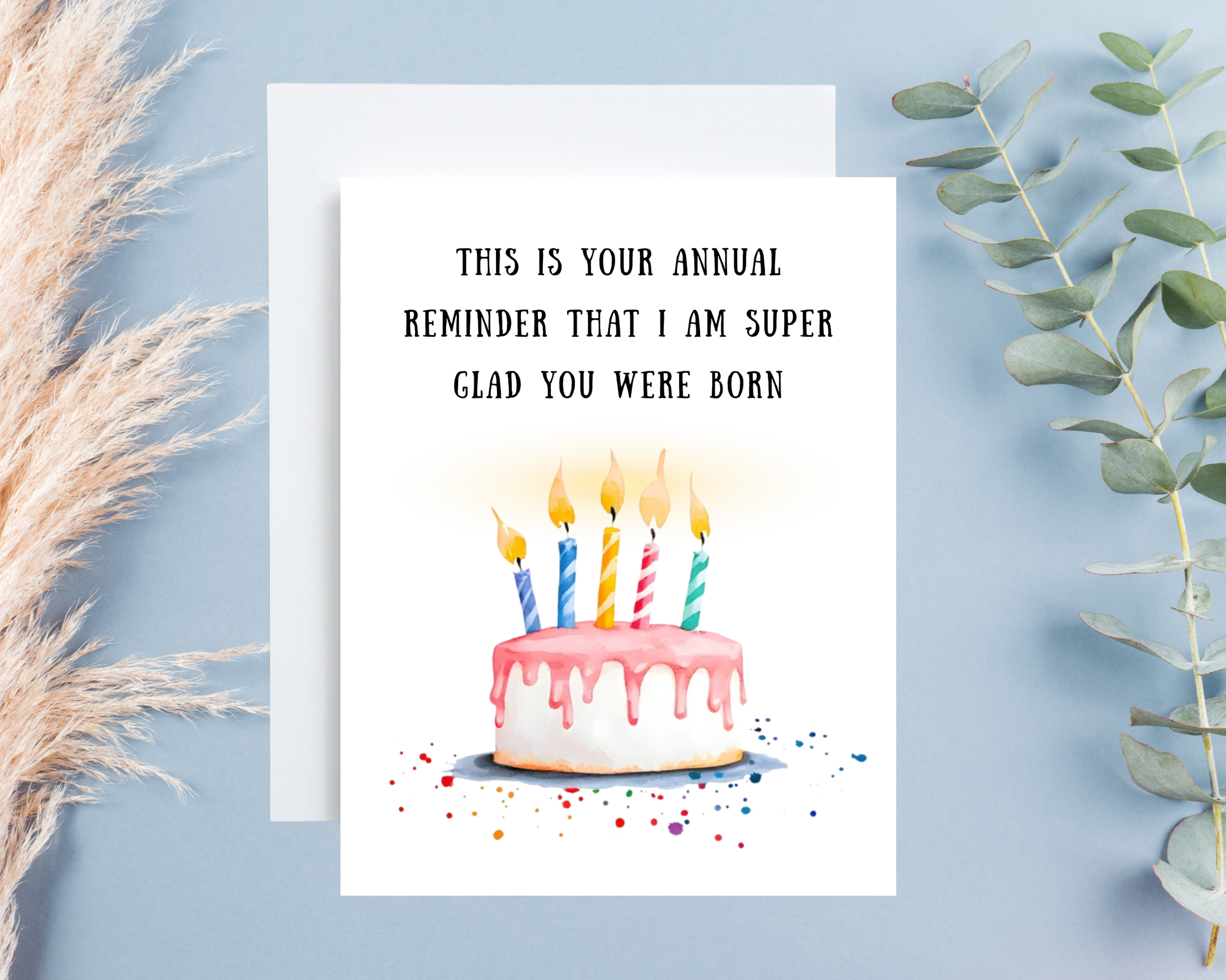 Greeting card with birthday cake illustration and humorous text on a light blue background.