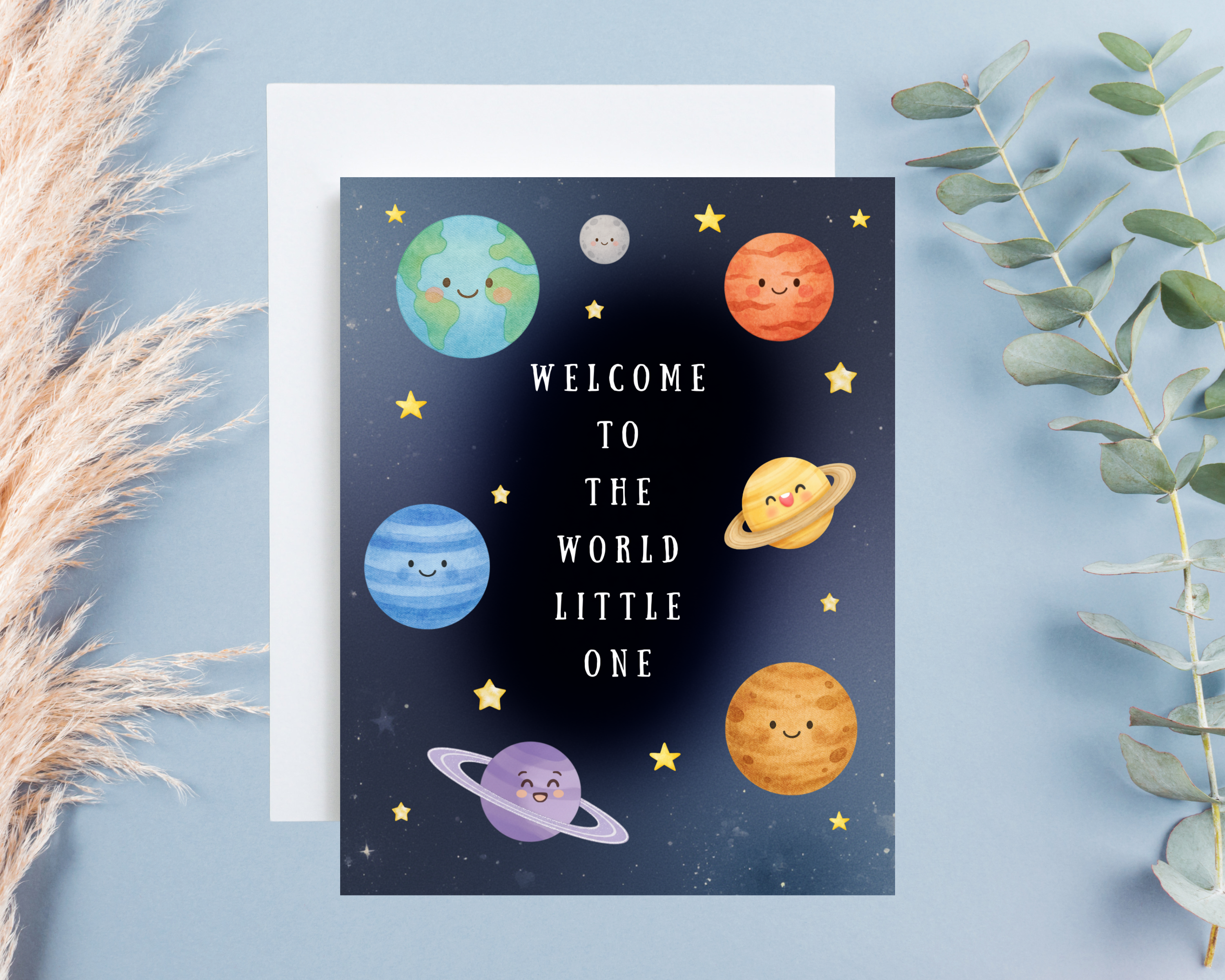 Greeting card with cartoon planets and text 'Welcome to the world little one' on a blue background.