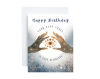 Greeting card with hands holding a moon symbol and 'Happy Birthday Your Next Phase Is Just Beginning' text on a white background