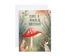 Greeting card with a red mushroom, fox, and rabbit in a forest setting with 'Have a Magical Birthday' text.